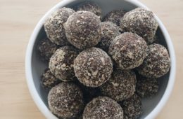 chocolate and raisin energy balls in a white bowl