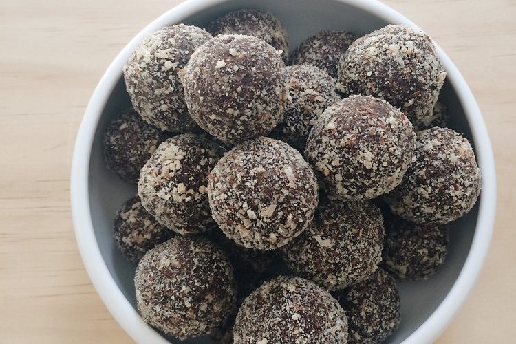chocolate and raisin energy balls in a white bowl