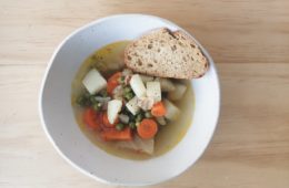vegetable soup in a bowl with a slice of bread