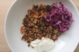 Greek Lamb Bake with Risoni, yoghurt and red cabbage salad in a white bowl