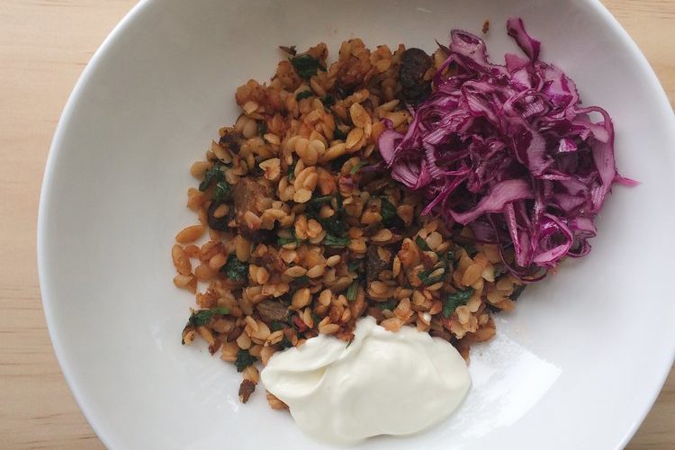 Greek Lamb Bake with Risoni, yoghurt and red cabbage salad in a white bowl
