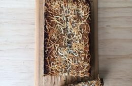 Vegan Banana Bread with Coconut Sprinkles on a wooden board