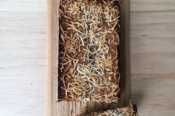 Vegan Banana Bread with Coconut Sprinkles on a wooden board