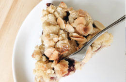 Cherry and Marzipan Streusel on a white plate with a cake fork