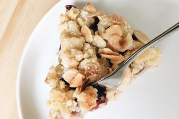 Cherry and Marzipan Streusel on a white plate with a cake fork