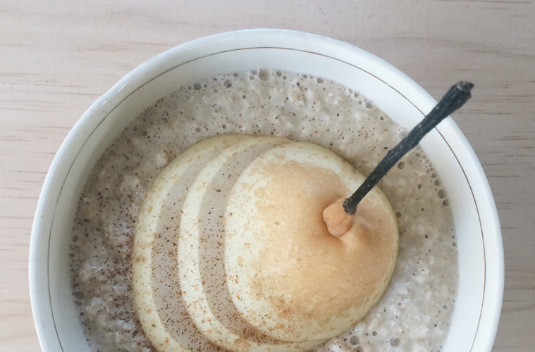 Nashi Pear and Maple Porridge in a white bowl with nashi pear slices on top