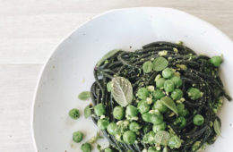 Parsley and Cashew Pesto with squid ink spaghetti on a white plate