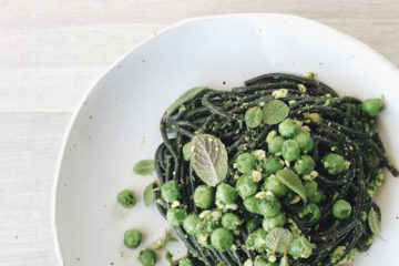 Parsley and Cashew Pesto with squid ink spaghetti on a white plate