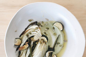 Sunflower Zucchini Hommus on a white plate with roasted fennel, zucchini and green beans