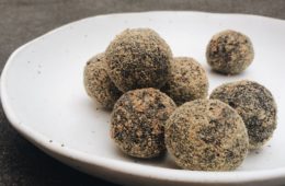 Cacao, Brazil Nuts and Flaxseed Bites on a white plate