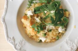 Pumpkin and Goats Cheese Risotto in a white bowl with rocket