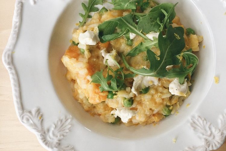 Pumpkin and Goats Cheese Risotto in a white bowl with rocket