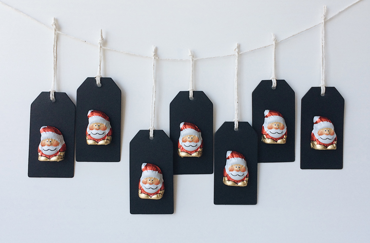 Minimal Advent calendar - mini chocolate santas on black tags that hang of a string