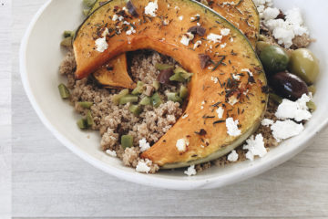 Roasted Pumpkin on Spelt Couscous in a white bowl sprinkled with feta and olives