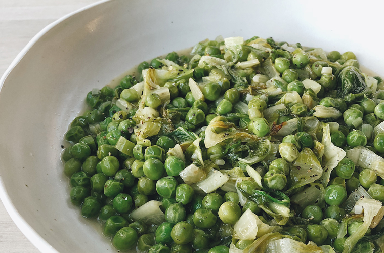 French braised Peas on a white plate