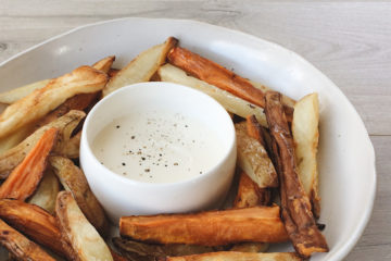 Mixed Oven Fries with a jar of aioli on a white plate