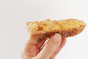 cumquat jam on a slice of bread held up by a hand