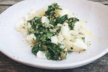 salsa verde with potatoes on a white plate