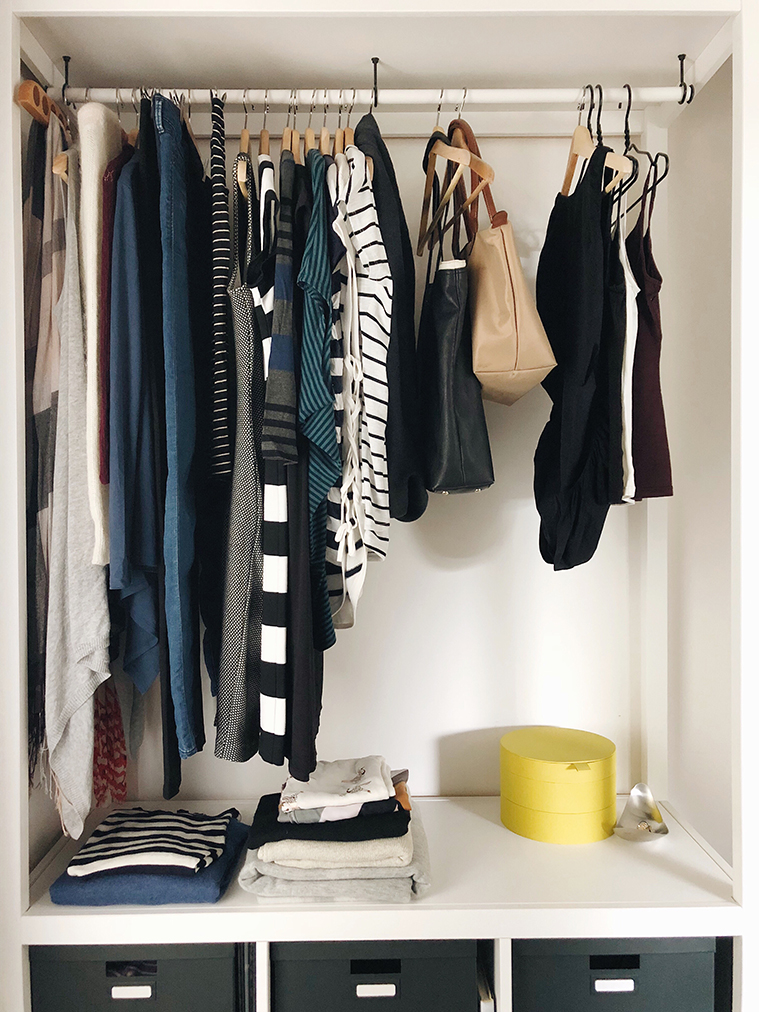 Full open wardrobe, clothes hanging and folded