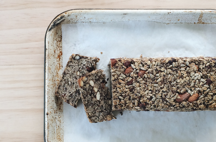 Seeded Nut Loaf on a lined baking tray on a light wooden surface