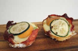 bacon and egg bites on a wooden surface