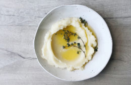 celeriac mash on a white plate with thyme