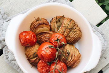 hasselback potatoes in a white roasting pan