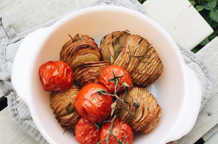hasselback potatoes in a white roasting pan