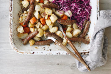Roasted Veg with lamb sausages recipe on a roasting tray with servers