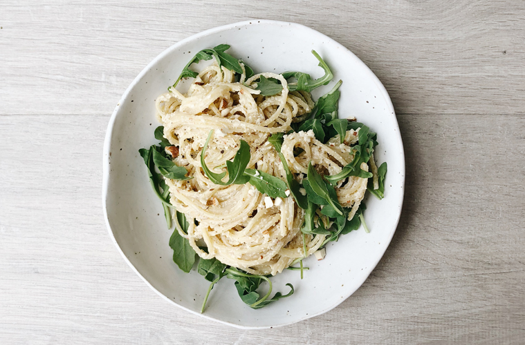 roasted garlic and artichoke spaghetti on a white plate