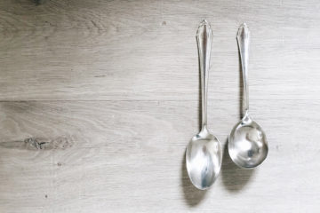 cleaned silver spoons on a wooden surface