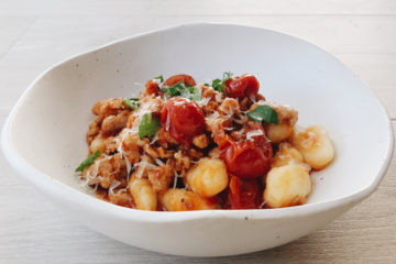 gnocchi with sausage and fennel in a white bowl