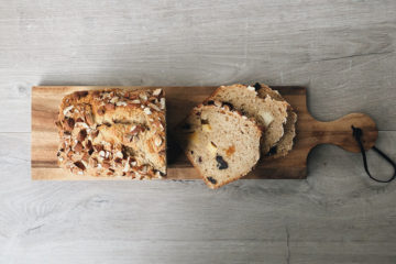 breakfast fruit and almond loaf sliced on a wooden board