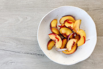 peach, lime and chilli salad in a white bowl